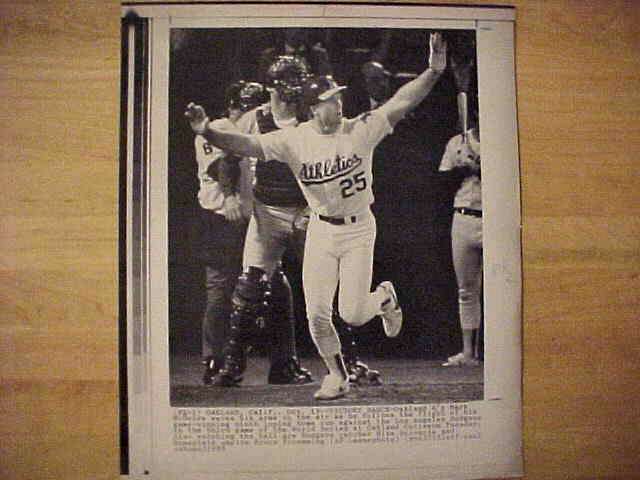 WIREPHOTO: Mark McGwire - {10/19/88} 'Victory Dance' (Athletics) Baseball cards value