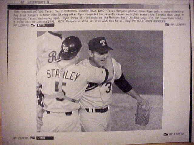 WIREPHOTO: Nolan Ryan - [05/02/91] 'Catching Congratulations' (Rangers) Baseball cards value
