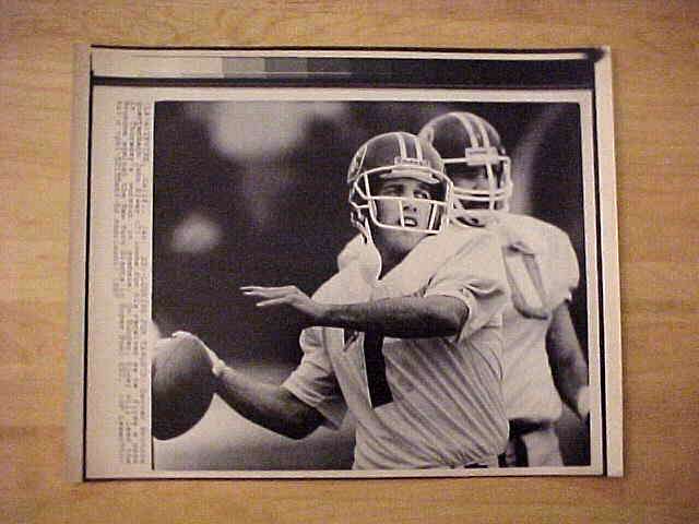 WIREPHOTO: John Elway - {01/23/87} 'Looking For Targets' (Broncos) Football cards value